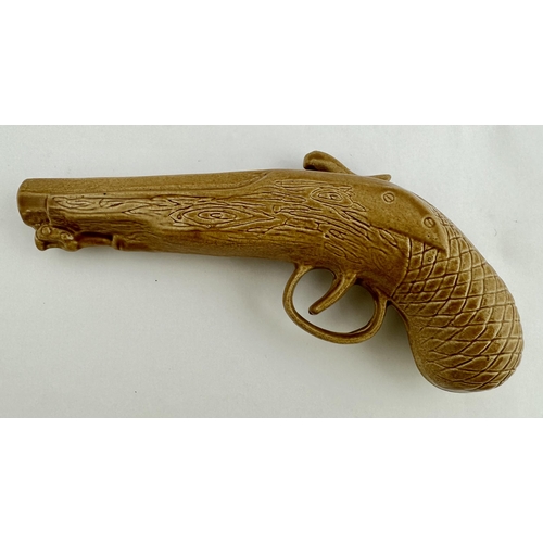 77 - ROCKINGHAM TYPE GLAZED PISTOL FLASK. 10.9ins long. An unusual shiny brown glazed flintlock pistol fl... 