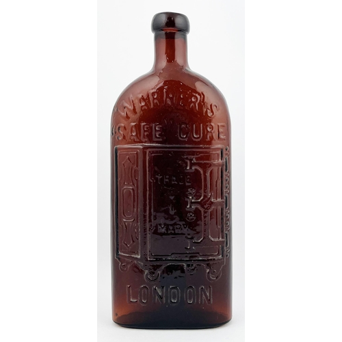 673 - LONDON WARNERS SAFE CURE BOTTLE. 9.25ins tall. Deep amber/ red. Safe motif to centre, embossed lette... 