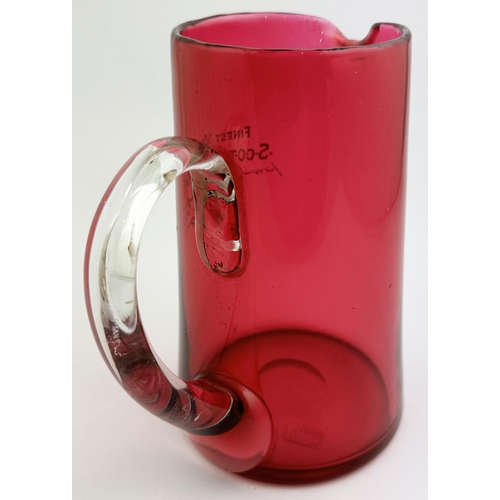 38 - DANIEL CRAWFORD SCOTCH WHISKY PUB JUG. 7.3ins tall. Vivid cranberry glass large size jug finely engr... 