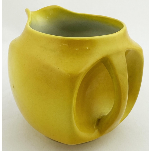 77 - COOMBES WATER JUG. 3.7ins tall. Bright yellow body with drinking gent pict below lip & rear handle w... 