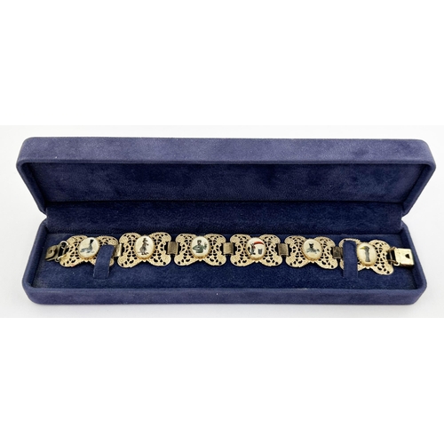 203 - GUINNESS BOXED BRACELET. Box 8.5ins long, 2.1 wide, 1.2 high. Padded blue velvet case. Shiny gold co... 