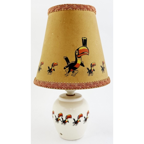 207 - GUINNESS LAMP BASE & SHADE. 10.5ins tall. Curved cream glazed base with toucans encircling middle.Ba... 