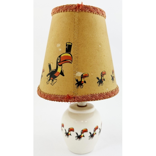 207 - GUINNESS LAMP BASE & SHADE. 10.5ins tall. Curved cream glazed base with toucans encircling middle.Ba... 