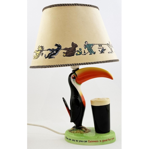 210 - GUINNESS TOUCAN LAMP BASE & SHADE. 17ins tall. 210. Multi colopured toucan on green, lettered, base,... 