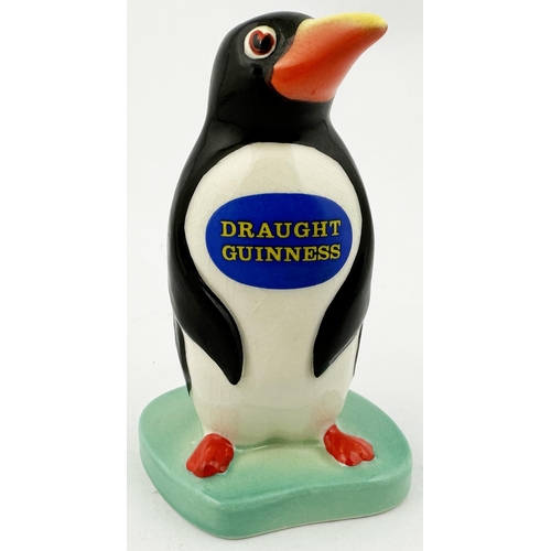 222 - GUINNESS PENGUIN FIGURE. 3.7ins tall. Naturalistically coloured penguin, DRAUGHT GUINNESS on blue ov... 