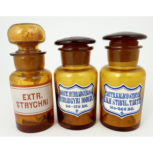 57 - LABELLED PHARMACY ROUNDS. Tallest 4.2ins. Golden amber each with ground glass stoppers - one filled ... 