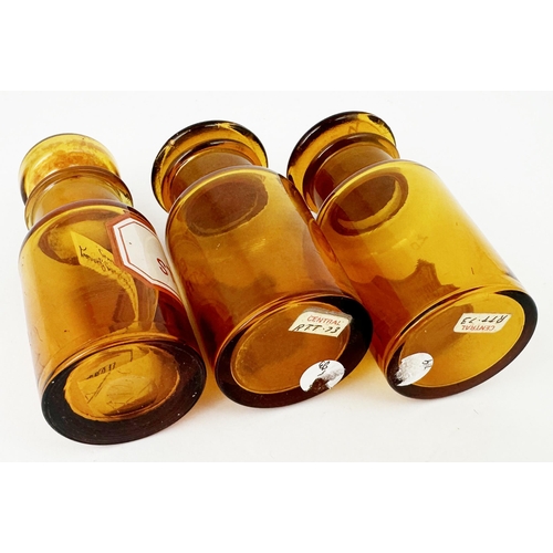 57 - LABELLED PHARMACY ROUNDS. Tallest 4.2ins. Golden amber each with ground glass stoppers - one filled ... 