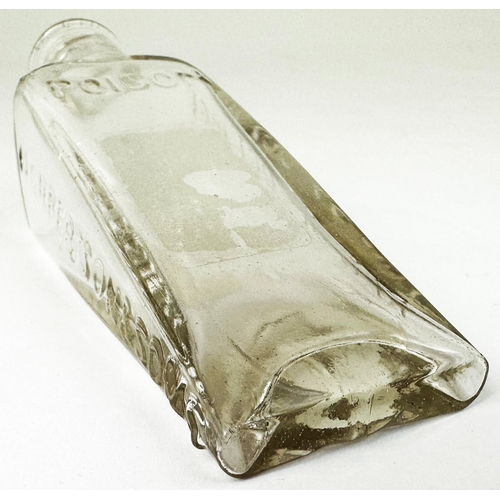 89 - GILBERTSONS WEDGE PATENT POISON BOTTLE. DP p22). Clear lead glass wedge shape. Very heavily & crispl... 