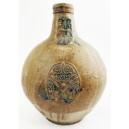 142 - BELLARMINE JUG. 11.6ins tall. Mid size quite bulbous bodied baluster shape, hand applied rear handle... 