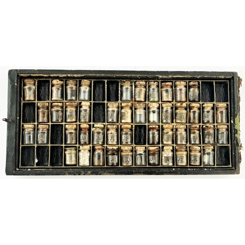 128 - MINIATURE APOTHECARY JARS SAMPLE CASE. Shallow case (7.25 x 3.35ins) contains miniature corked lidde... 