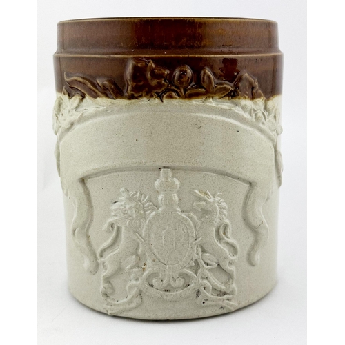 32 - TOBACCO JAR. 6.25ins tall. Coat of arms to front with plain banner above. Minor base chip.