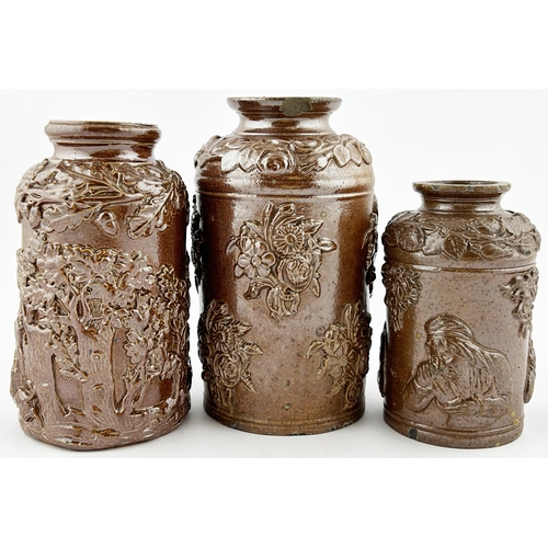 370 - TOBACCO JAR TRIO. Tallest 6.5ins. Stoneware, heavily sprigged, various designs. Damages. (3)