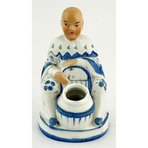 38 - CHINESE TYPE FIGURAL INKWELL. 4ins tall. Seated man with inkwell to front. Base chips.