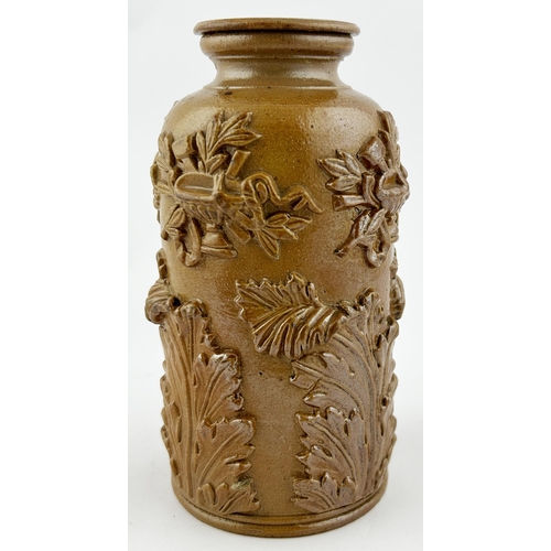 421 - SPRIGGED TOBACCO JAR. 6ins tall. Treacle glaze, heavily sprigged with floral design. Chips.