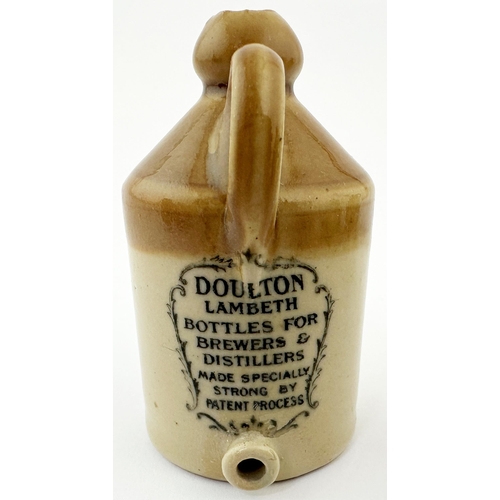 514 - DOULTON LAMBETH MINIATURE FLAGON. 2.75ins tall. Tan top, black transfer. Handle & spigot to front. R... 