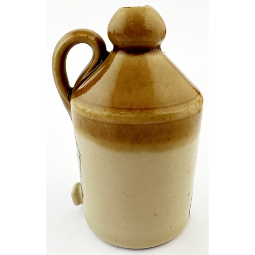 514 - DOULTON LAMBETH MINIATURE FLAGON. 2.75ins tall. Tan top, black transfer. Handle & spigot to front. R... 