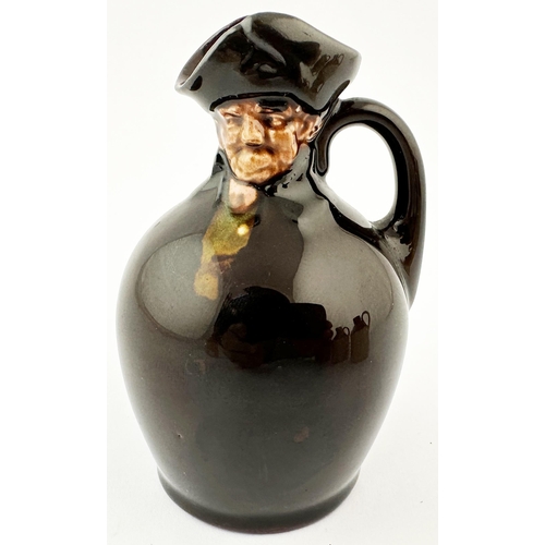 517 - MINIATURE ROYAL DOULTON KINGSWARE FLASK. 3.5ins tall. Dark treacle glaze with modelled head top in t... 