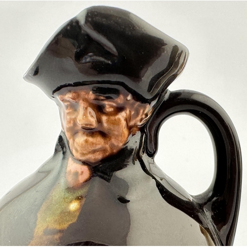 517 - MINIATURE ROYAL DOULTON KINGSWARE FLASK. 3.5ins tall. Dark treacle glaze with modelled head top in t... 