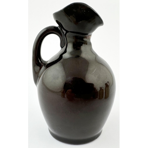 517 - MINIATURE ROYAL DOULTON KINGSWARE FLASK. 3.5ins tall. Dark treacle glaze with modelled head top in t... 