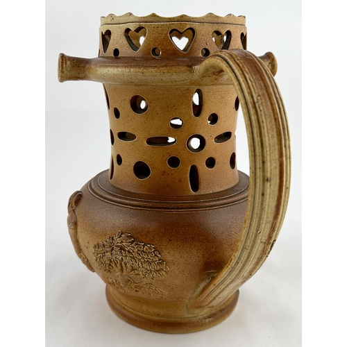 529 - SALT GLAZE PUZZLE JUG. 7.75ins tall. Dull glaze. Pierced with mid brown salt glaze. Hearts cut out a... 