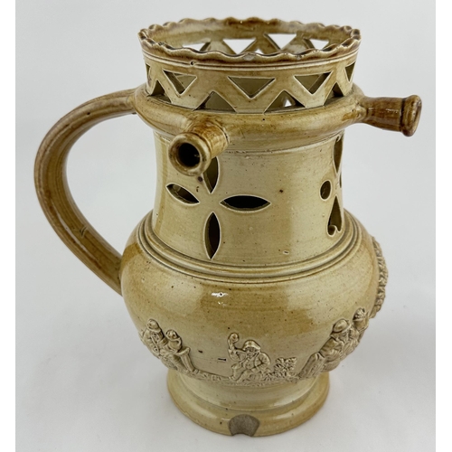 530 - SALT GLAZE PUZZLE JUG. 7.75ins tall. Shiny glaze. Pierced with flower & hearts, sprigged with smokin... 