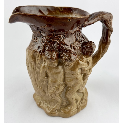 533 - SALT GLAZE SATYRS JUG. 6.25ins tall. Heavily modelled - one side featuring young persons with a donk... 