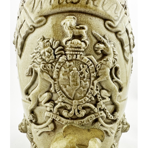 625 - WHISKEY SLIP GLAZE BARREL. 8.25ins tall. Coat of arms to front, sprigged with lion & leaves at eithe... 