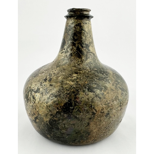 636 - ENGLISH ONION WINE BOTTLE. 6.2ins tall, dense black glass. Attractive overall patinated/ irridescent... 