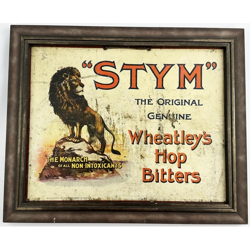 17 - WHEATLEYS STYM HOP BITTERS FRAMED SHOWCARD. 12 x 14.5ins. Familiar lion on rock pict. t.m. for this ... 