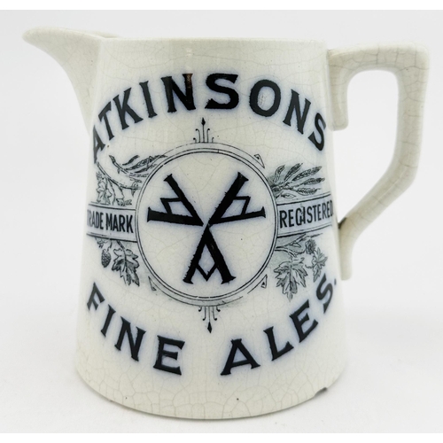 25 - ATKINSONS ALES & SPIRITS BEER JUG. 4.8ins tall, pouring lip, rear handleDeep blue transfer each side... 