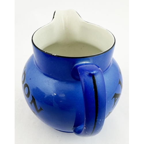 26 - COURAGE LONDON STOUT WATER JUG. 4.1ins tall, pouring lip, rear handle. Uneven mid blue body glaze. R... 