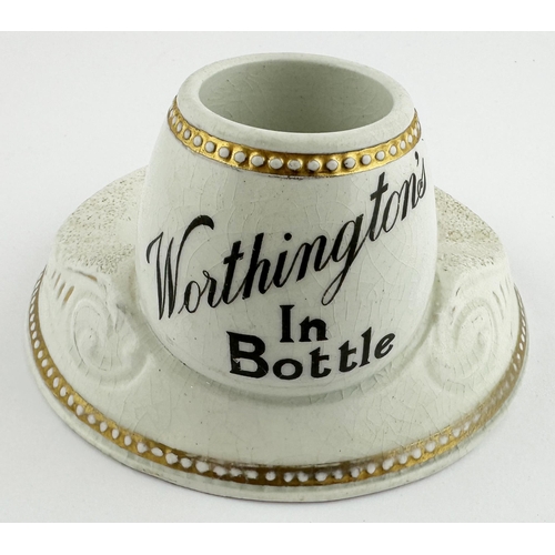 42 - WORTHINGTON IN BOTTLE MATCHSTRIKER & ASHTRAY. 5.5ins diam. Large footed base with slopping to either... 
