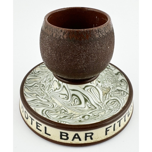 46 - LEEDS BAR FITTERS ADVERTISING MATCHSTRIKER HOLDER & ASHTRAY. 4.75ins diam. Footed base with letterin... 