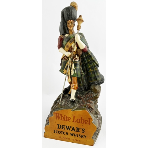 77 - DEWARS SCOTCH WHISKY ADVERTISING FIGURE. 12ins tall. A very rare, larger size, rubberoid kilted man ... 