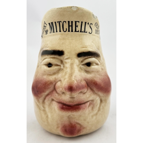79 - BELFAST MITCHELLS OLD IRISH WHISKY HEAD JUG. 6.25ins tall. Character jug on form of smiling head, ad... 