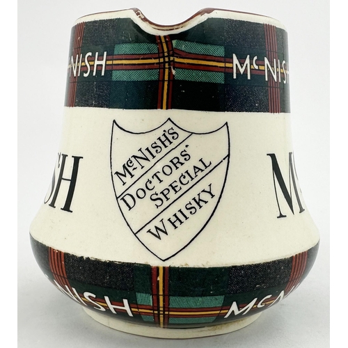 91 - MCNISH WHISKY JUG. 4ins tall. Tartan design to neck & base. Red rim and handle. Special Scotch shiel... 