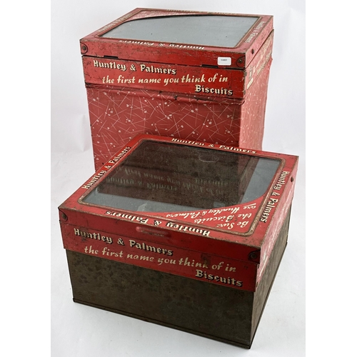 113 - HUNTLEY & PALMERS BISCUITS TINS DUO. Largest 10.5 x 9.25ins. Clear glass, hinged, lids. Heavy. Worn.... 