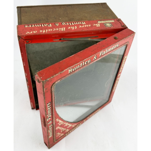 113 - HUNTLEY & PALMERS BISCUITS TINS DUO. Largest 10.5 x 9.25ins. Clear glass, hinged, lids. Heavy. Worn.... 