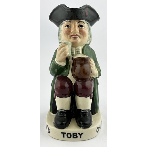 118 - TOBY ALE & STOUT TOBY JUG. 9.1ins tall. Familiar multi-coloured seated red cheeked toper, glass in h... 