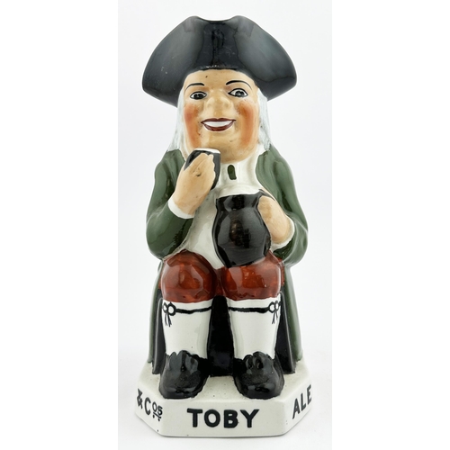 122 - TOBY ALE & STOUT TOBY JUG 9ins tall. Familiar multi-coloured seated red cheeked toper, glass in hand... 