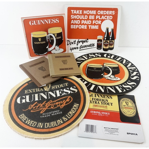 129 - . GUINNESS MIXED GROUP. Inc. Books, box, card advert, perspex stand up sign & mats. Worn. (7)