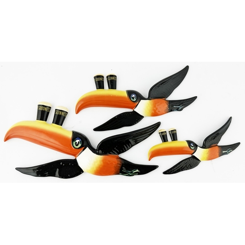 134 - GUINNESS WALL HANGING FLYING TOUCANS. Longest 10ins. Set of three classic multi coloured Toucans. Ca... 