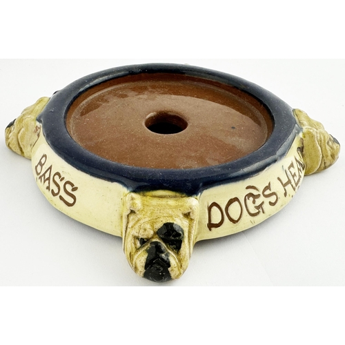 248 - GUINNESS DOGS HEAD BASS DOGS HEAD BAR TOP SYPHON STAND? 6.6ins diam. Four sculpted dogs head feet su... 