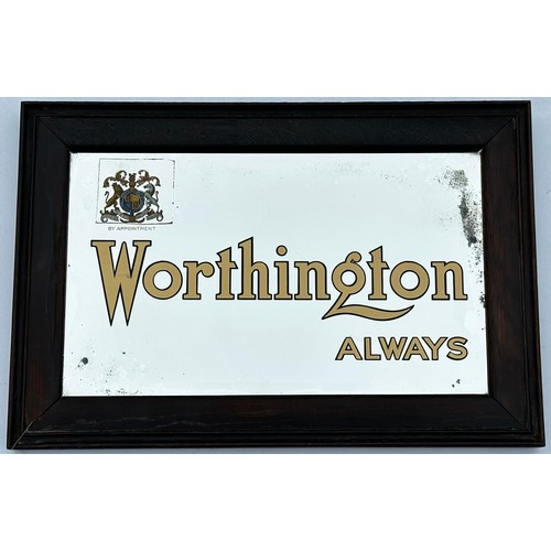 153 - WORTHINGTON ALWAYS FRAMED MIRROR. 18.5 x 12.75ins. Dark frame, coat of arms to top left. worn undern... 