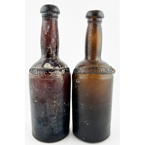 66 - RIBBON SEALED LIQUEUR BOTTLES DUO. 9ins tall. Deep amber/ red with applied ribbon seal PETERS, base ... 