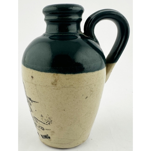 593 - GOD SAVE THE KING MINIATURE GREEN TOP WHISKY JUG. WG p47. 4ins tall. Dark green top section, lower o... 