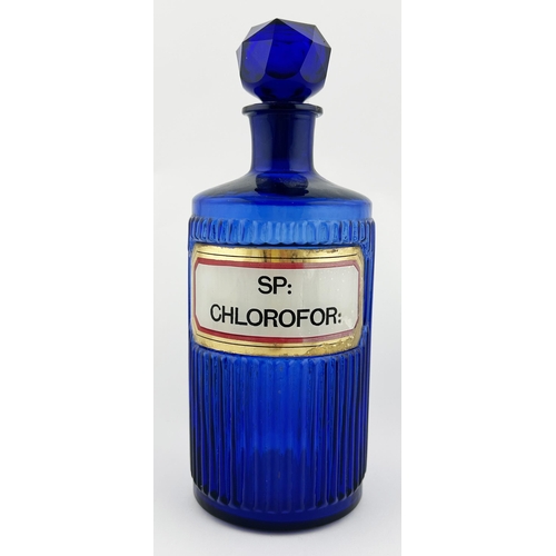 161 - CHEMIST ROUND. 8.25ins tall. Blue ribbed, label under glass with stopper. Damage to label.