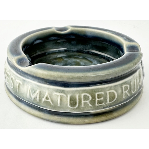 427 - RUM ADVERTISING DOULTON LAMBETH ASHTRAY. 3.9ins diam. Chunky stoneware ashtray, raised lettering aro... 