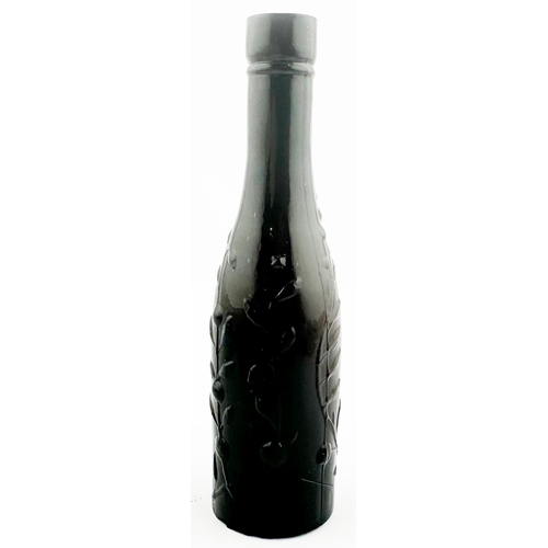 445 - MINIATURE SAMPLE CORDIAL BOTTLE. 5ins tall. Black/ very dark amber colour. Heavily embossed leaf des... 