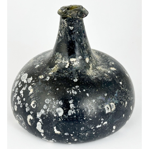 458 - ENGLISH ONION WINE BOTTLE. 5.7ins tall. Couple of lip chips. Dark/ black glass, heavy, internal buri... 